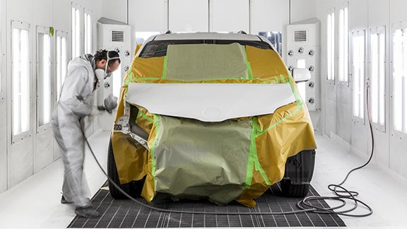 Collision Center Technician Painting a Vehicle | Woodrum Toyota of Macomb in Macomb IL
