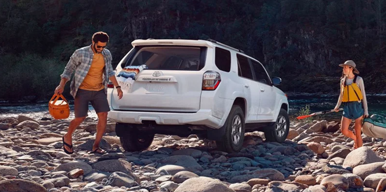 A 2024 Toyota 4Runner parked on a rocky shore .