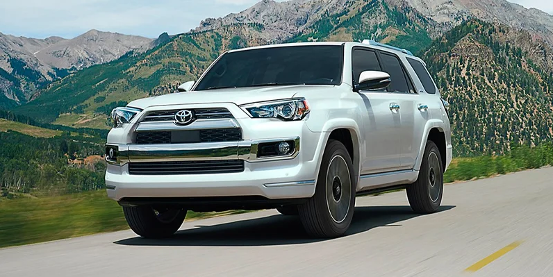 A white 2024 Toyota 4Runner driving down the streets of Macomb, IL near Woodrum Toyota of Macomb.