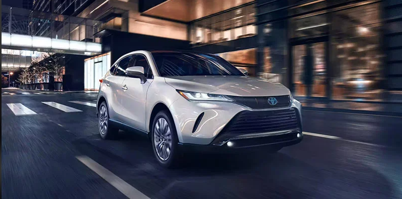 A silver 2024 Toyota Venza driving down the road.