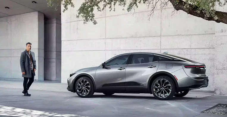 A man walking toward the drivers side door of a 2024 Toyota Crown.