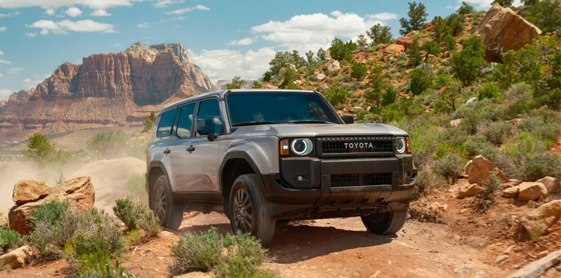 a Photo of a 2025 Toyota Land Cruiser driving down a dirt road.
