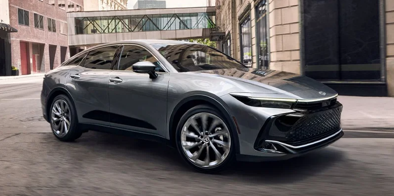 A photo of a silver 2025 Toyota Crown driving down the road.