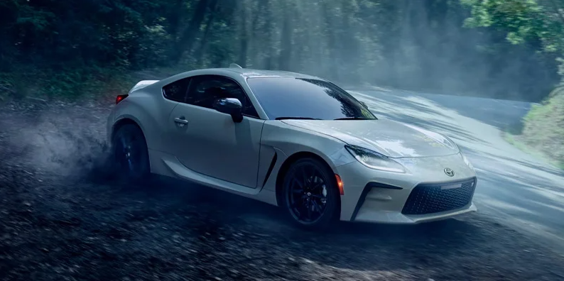 A photo of a white 2025 Toyota GR86 parked on the side of the road.