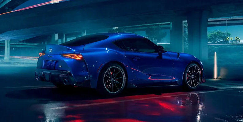 A blue Toyota GR Supra parked in a parking lot.