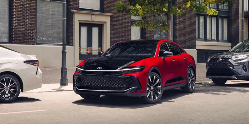 A red and black 2026 Toyota Crown parallel parking.