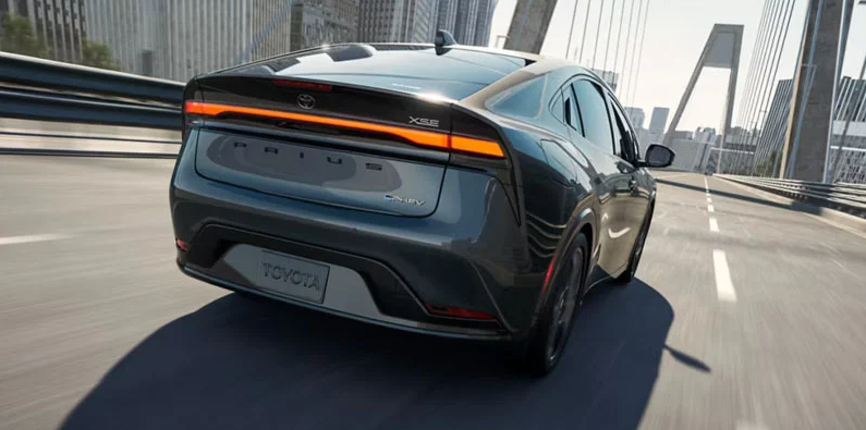 A 2026 Toyota Prius plug-in Hybrid driving down the road.