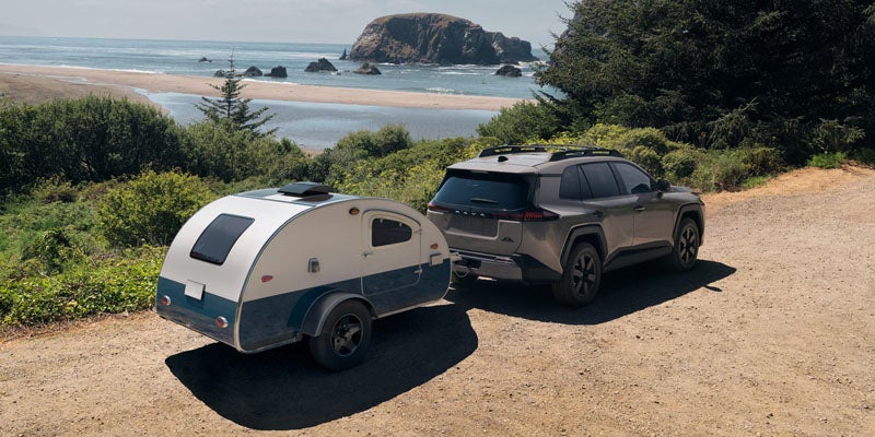 Gray 2026 Toyota RAV4 in Macomb towing luggage van seaside